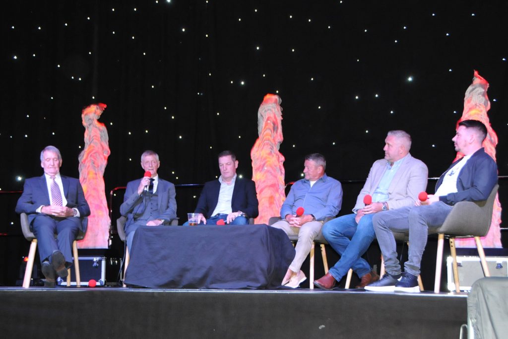 Barry Murphy, Allan Clarke, Gerry Taggart, Danny Wilson, Jon Parkin, Adam Hammill sitting on stage with a black backdrop and stars.