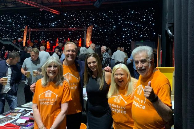 Barnsley Hospice volunteers in their orange Hospice t-shirts at Barnsley Metrodome Legends Night